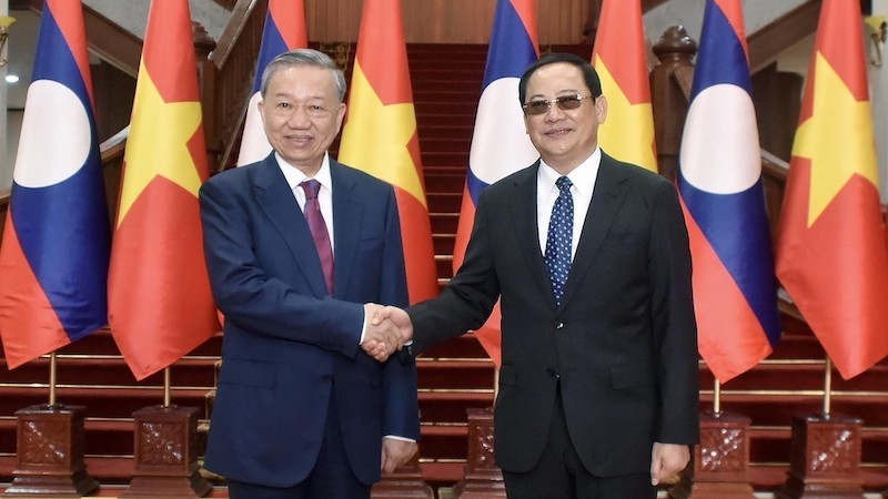 Президент То Лам и Премьер-министр Лаоса Сонсай Сипхандон. Фото: ВИА