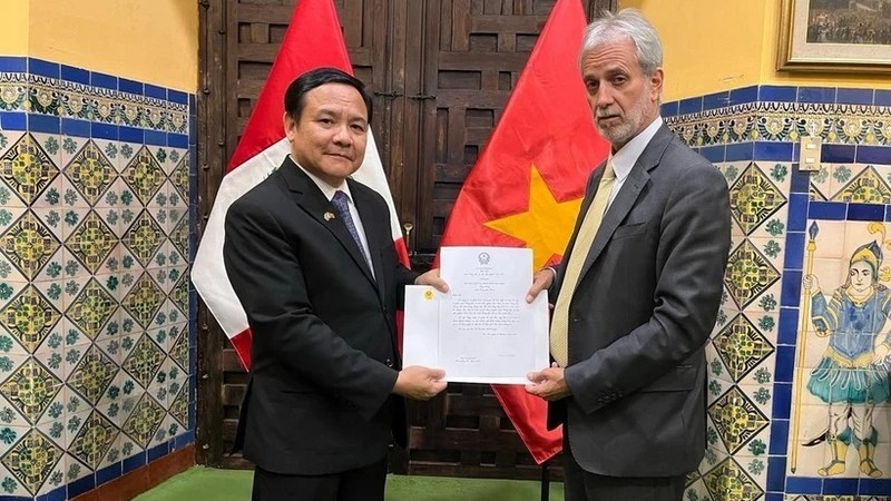 Посол Вьетнама Буй Ван Нги вручает копию верительных грамот Главе Департамента протокола Министерства иностранных дел Перу. Фото: ВИА