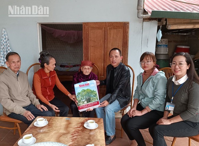 Представители газеты «Нянзан» поздравляют вьетнамскую мать-героиню c наступающим Тэтом. 