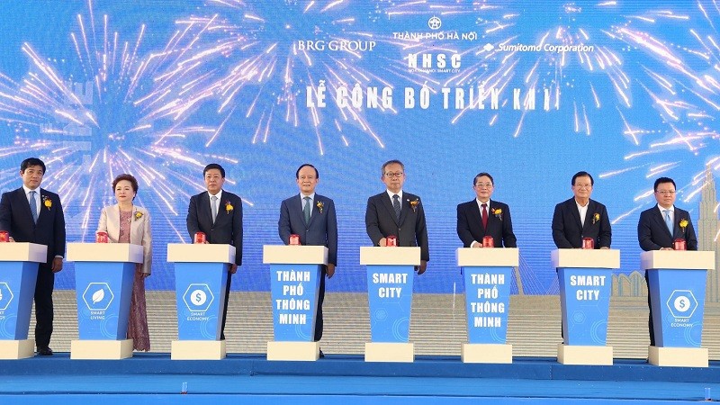 Делегаты нажимают кнопку в знак объявления о реализации умного города Северный Ханой.