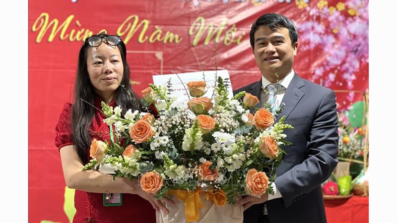 Генеральный консул Лыу Суан Донг (справа) вручает поздравительную корзину цветов представителю Общества. Фото: ВИА 