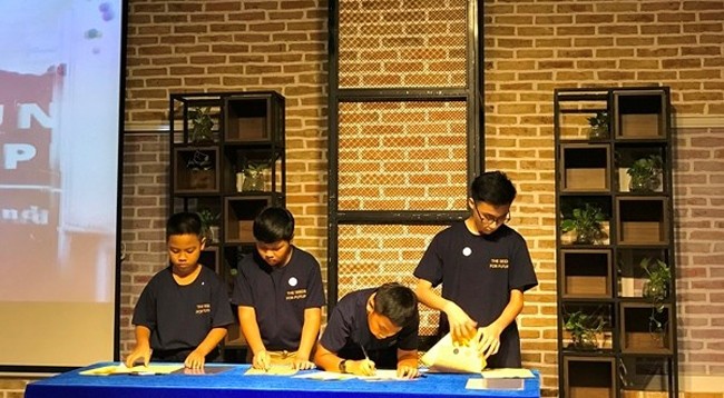 Том Фи Чунг Вьет (справа) – один из трех школьников SNA – подписывает обязательство сопровождать программу «STEM Ambassadors – The seeds for future». Фото: vietnamplus.vn