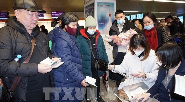 Сотрудники Посольства Вьетнама в Польше оказывают помощь вьетнамским гражданам в выполнении процедур в аэропорту. Фото: VNA 